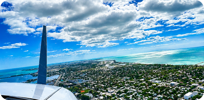 Cockpit view over ocean and islands during a discovery flight